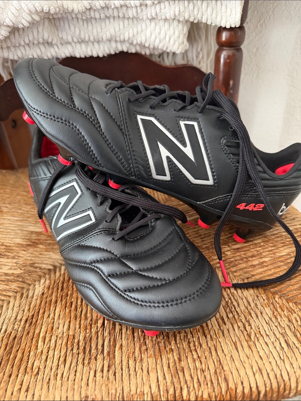 New Balance Black Soccer Cleats with Red Detail 442 Top model.